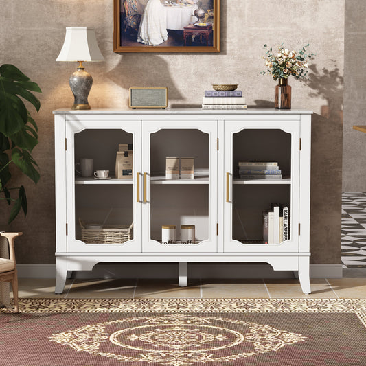 White 3-door storage cabinet with glass panels and gold handles in a modern dining room