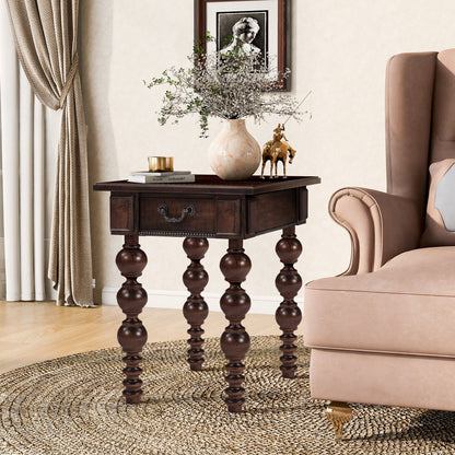Espresso wood end table with drawer and turned spindle legs beside a sofa in a living room