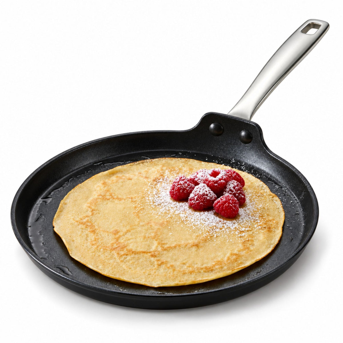 10-inch ceramic nonstick crepe pan with low sides and stainless steel handle holding a thin crepe