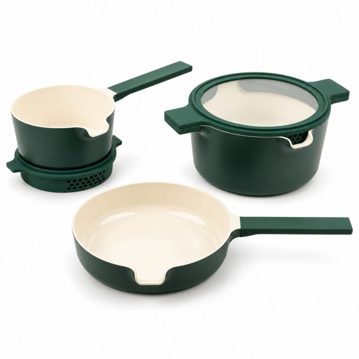 Green nesting ceramic nonstick cookware set stacked with glass strainer lids in a small kitchen