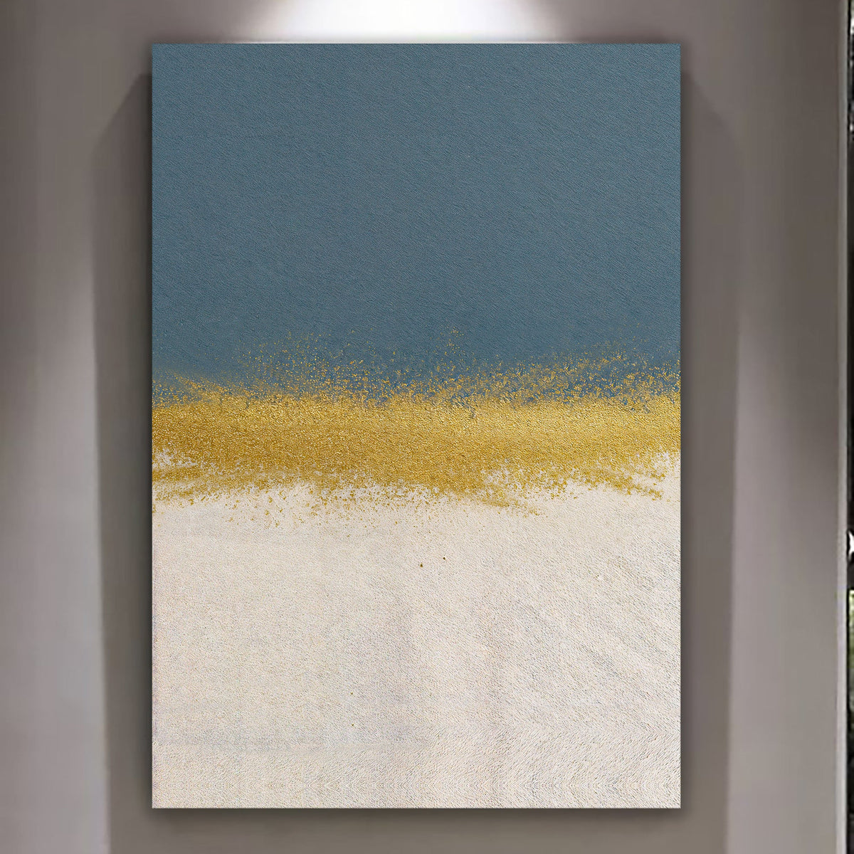 Minimalist blue and gold canvas wall art above a gray sofa with brass lamp