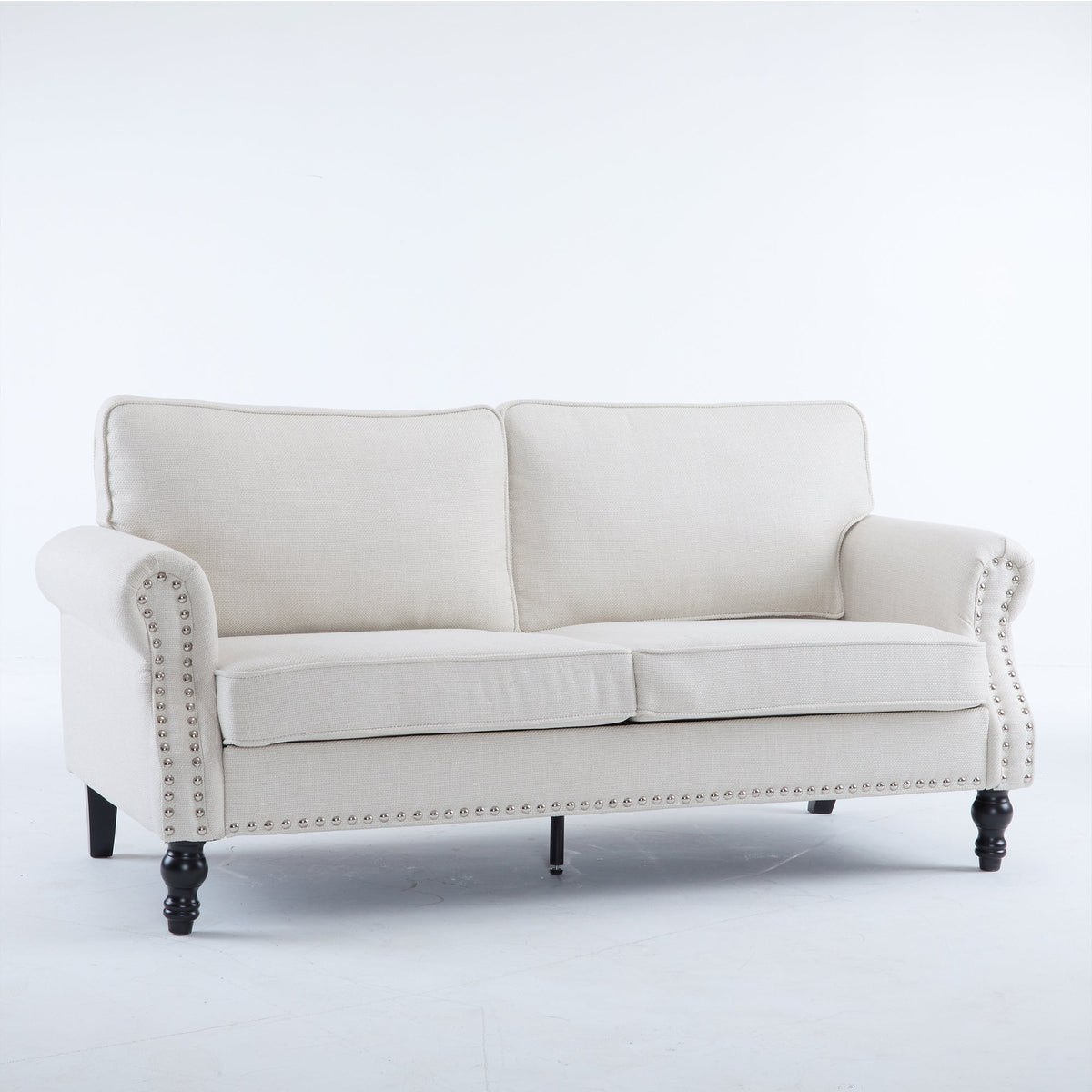 Beige faux leather rolled arm sofa with nailhead trim in a classic living room