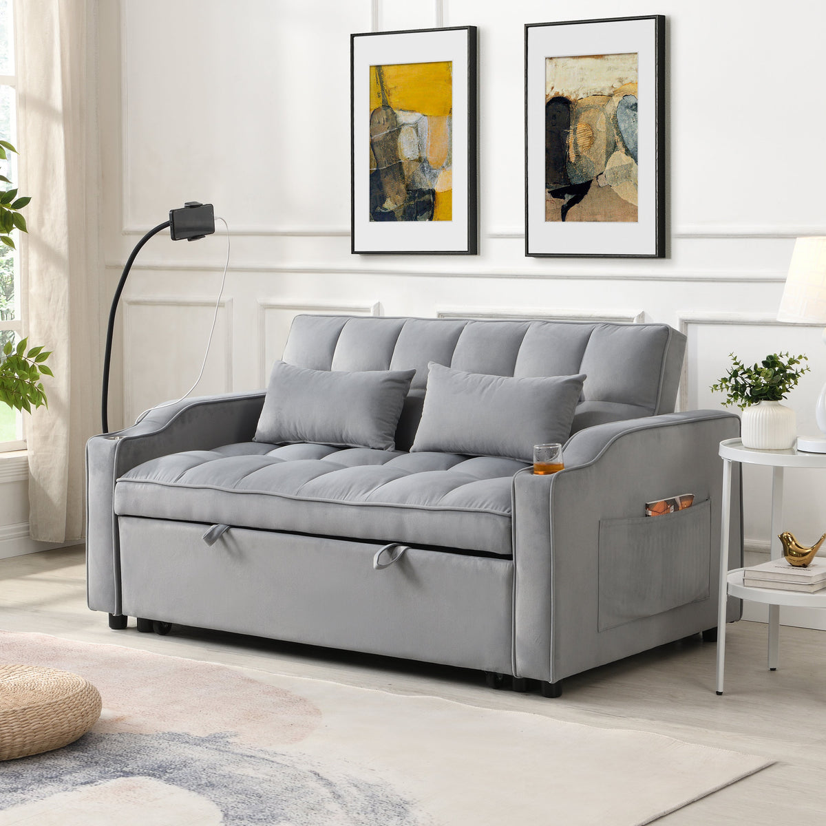 Light gray velvet sleeper loveseat with pullout bed and USB ports in a small apartment living room