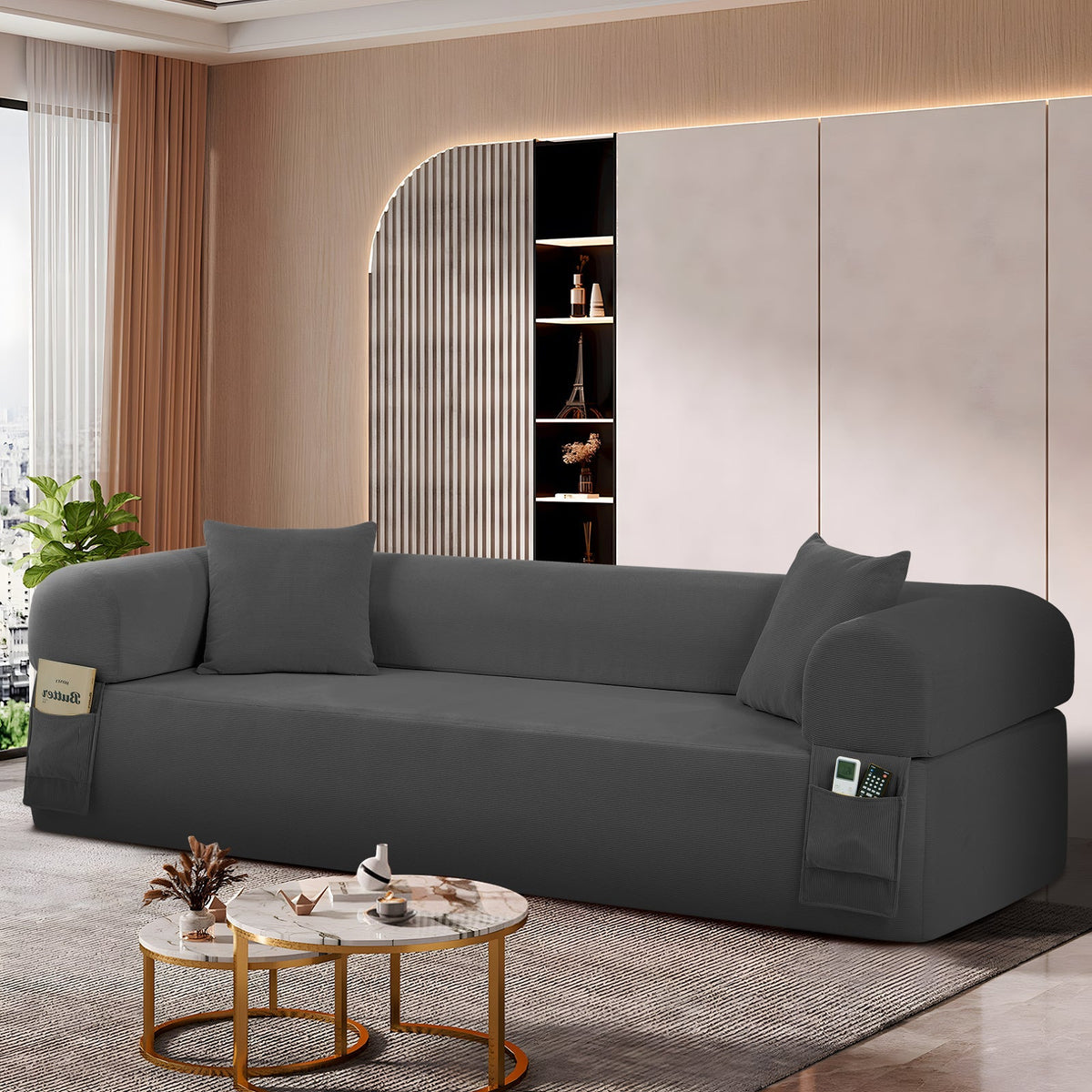Gray fabric spring sofa with side storage pockets and matching pillows in a modern living room