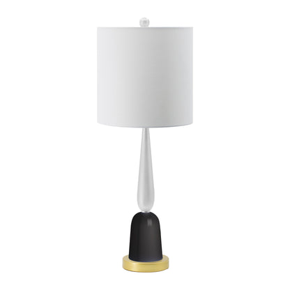 Black and gold teardrop table lamp with white cylindrical shade on a bedroom nightstand