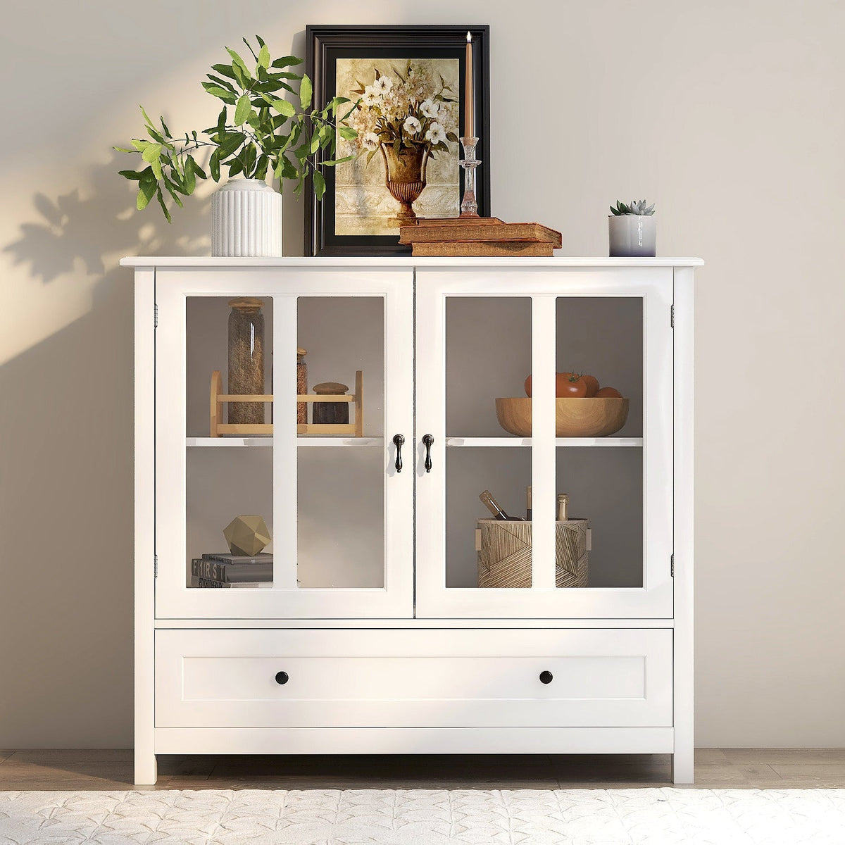 White buffet storage cabinet with double glass doors and bell handles in a bright kitchen