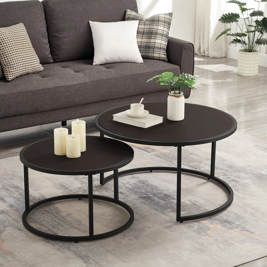 Two dark brown faux leather round nesting coffee tables with black metal bases in a modern living room