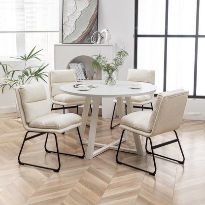 Innes vanilla white round dining table with four faux leather chairs in a small dining room