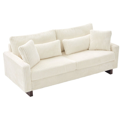 Dark gray modern fabric loveseat sofa with square and lumbar pillows in a contemporary living room
