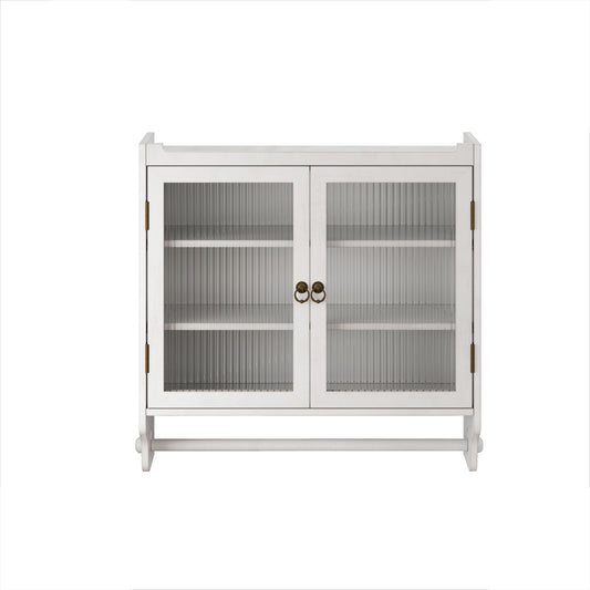 White washed solid wood medicine cabinet with fluted glass doors and towel rack on a bathroom wall