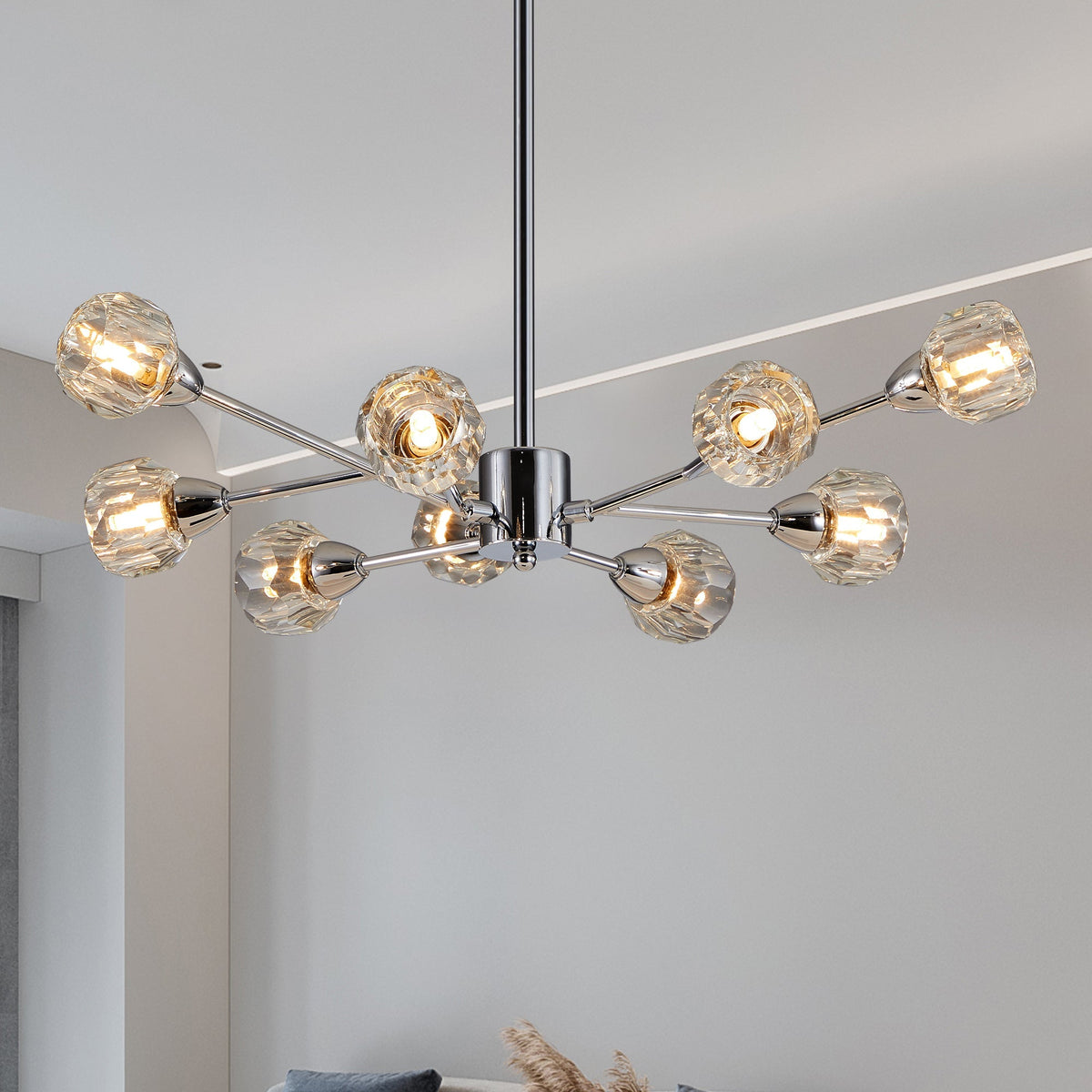 Chrome modern crystal chandelier with nine lights on a low ceiling above a dining table