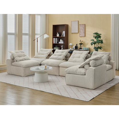 Beige corduroy 6-piece modular sofa set with neck pillows arranged as a sectional in an open living room