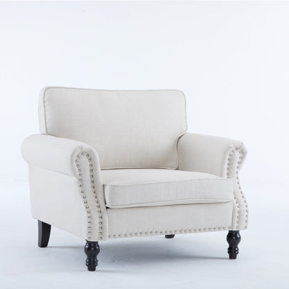 Beige faux leather accent chair with rolled arms and nailhead trim in a living room reading nook