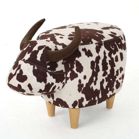 Black cow-shaped fabric ottoman footstool with wooden legs in a living room