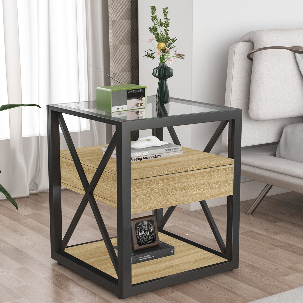 Modern natural wood end table with tempered glass top, drawer and X-frame beside a sofa