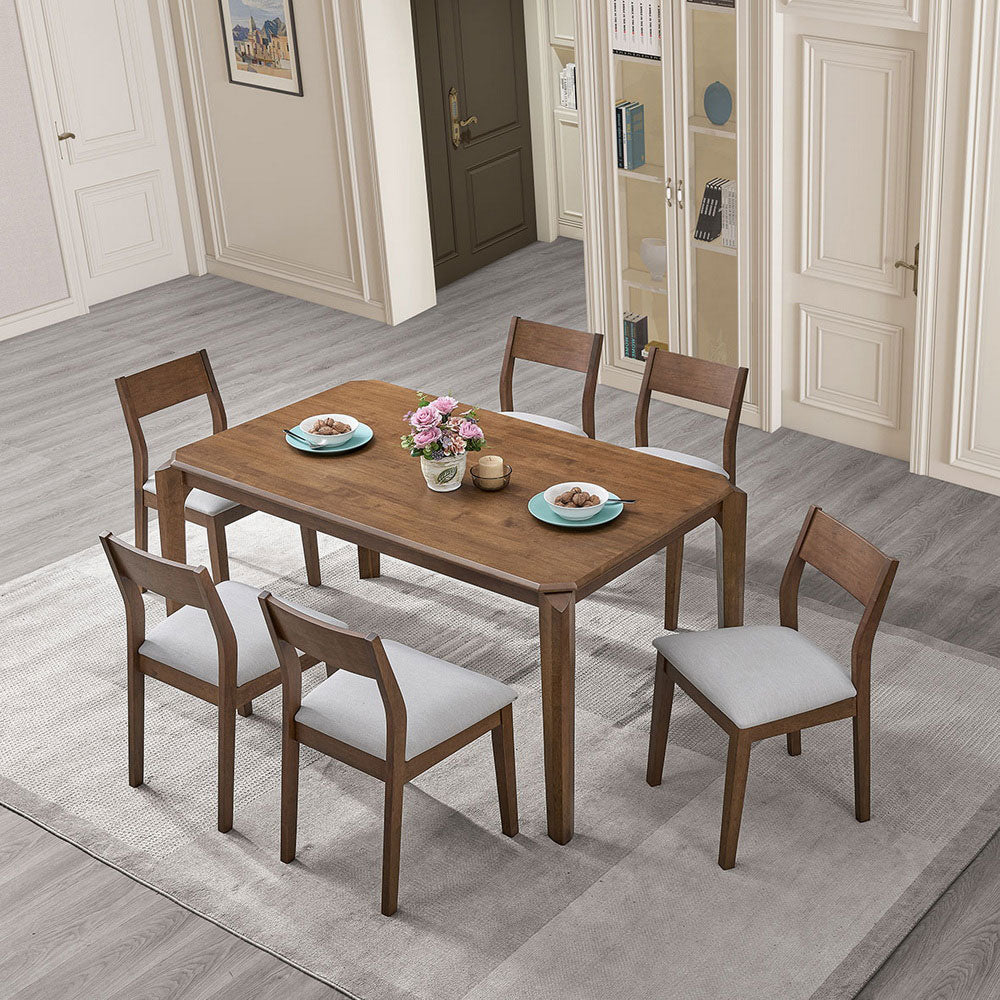 59-inch solid rubberwood walnut dining table with beige upholstered chairs in a compact dining room