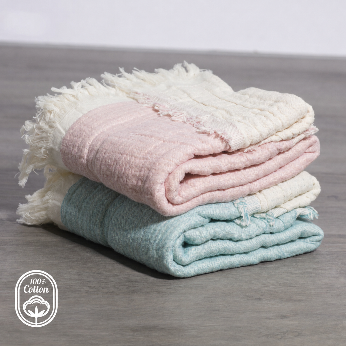 Pink reversible cotton muslin baby blanket in a nursery crib