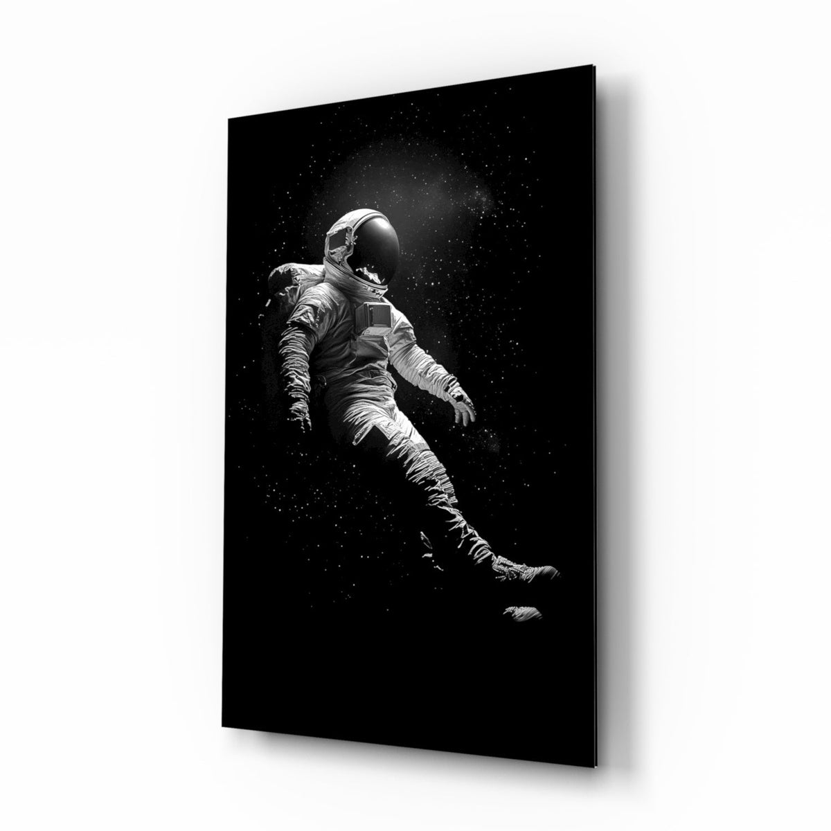 Lone astronaut drifting in starry black space glass wall art in a modern bedroom