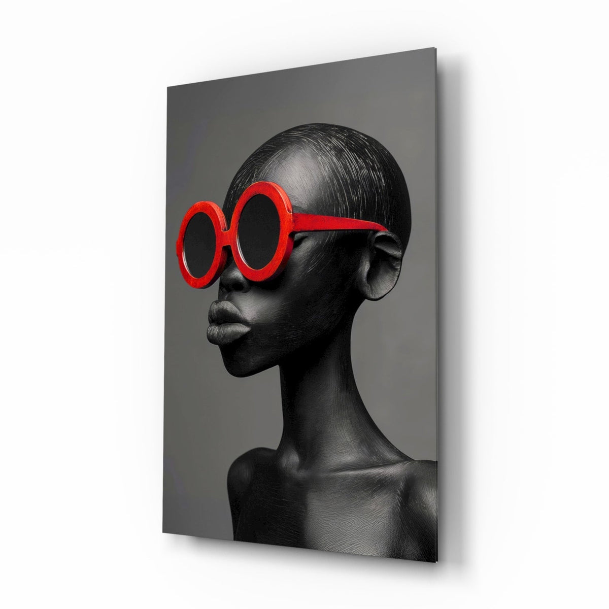 Gray female portrait glass wall art with red round sunglasses hanging on a dressing room wall