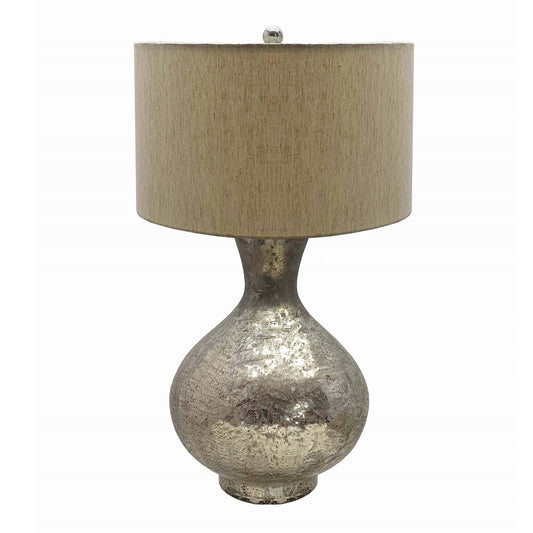 Silver mercury glass bottle table lamp with linen shade on a bedside table