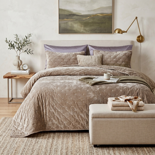 Sand taupe beige tufted velvet quilt set with shams on a bed in a neutral modern bedroom