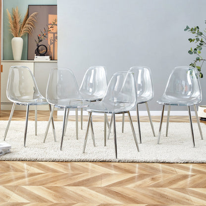 Six clear transparent PET dining chairs with silver metal legs around a modern dining table