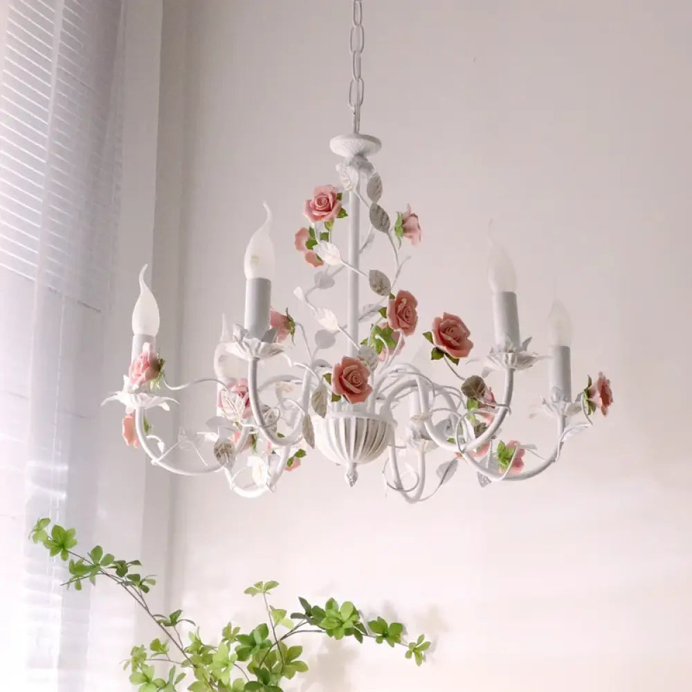 Charming pastoral iron chandelier hanging in a cozy country-style dining room