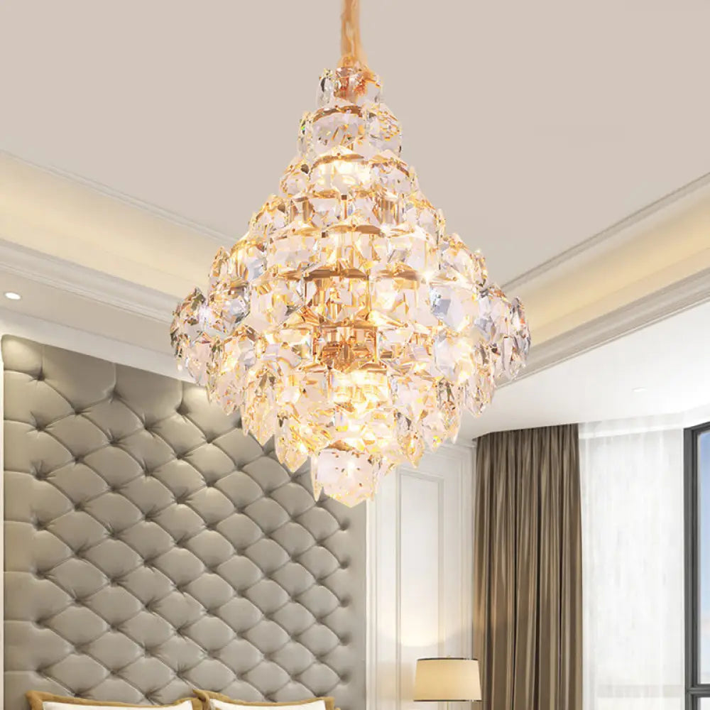 Clara gold crystal chandelier with cascading teardrop crystals above a dining table