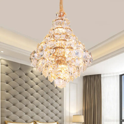 Clara gold crystal chandelier with cascading teardrop crystals above a dining table