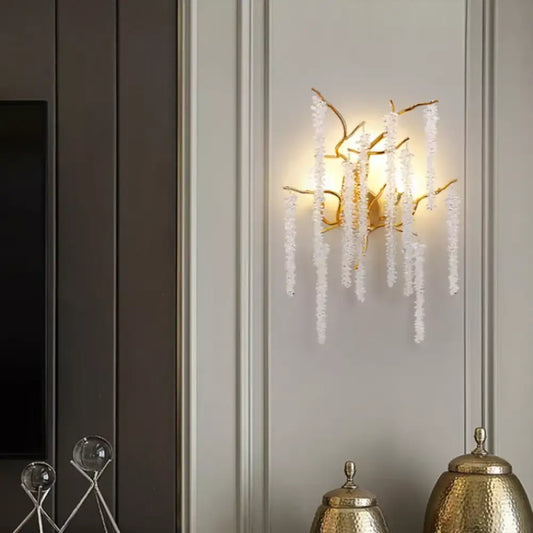 Gold crystal cherry blossom wall sconce with branching frame lighting a modern bedroom wall