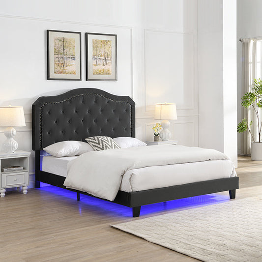 Queen velvet upholstered bed with curved button-tufted headboard and LED lights in a glam bedroom