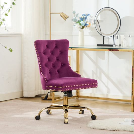 Purple velvet tufted office chair with nailhead trim and gold metal base at a home office desk