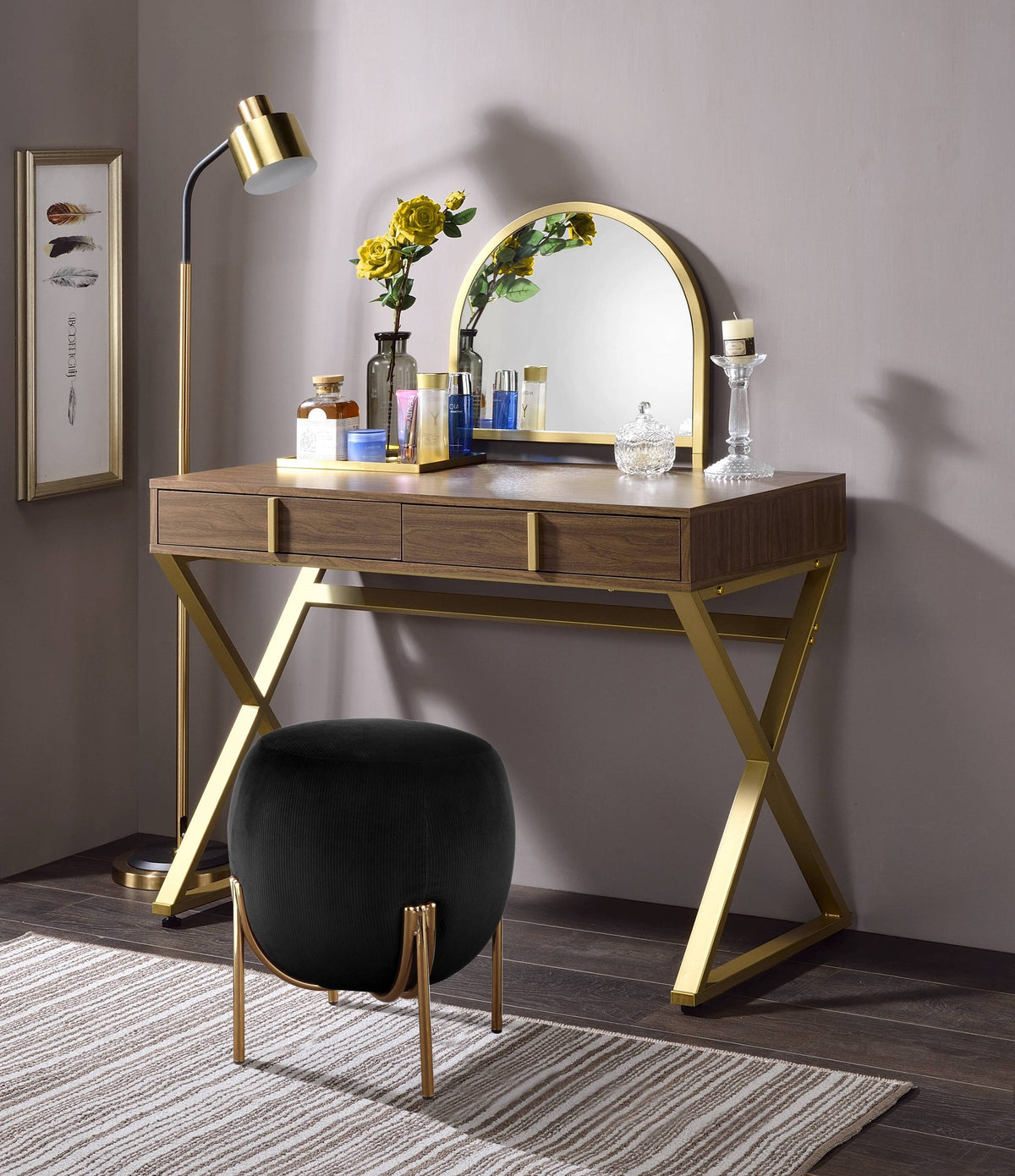 Walnut and gold vanity desk with mirror, jewelry tray and X-shape metal frame in a modern bedroom