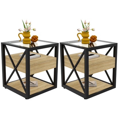 Set of two modern X-frame end tables with glass tops and drawers beside a bed