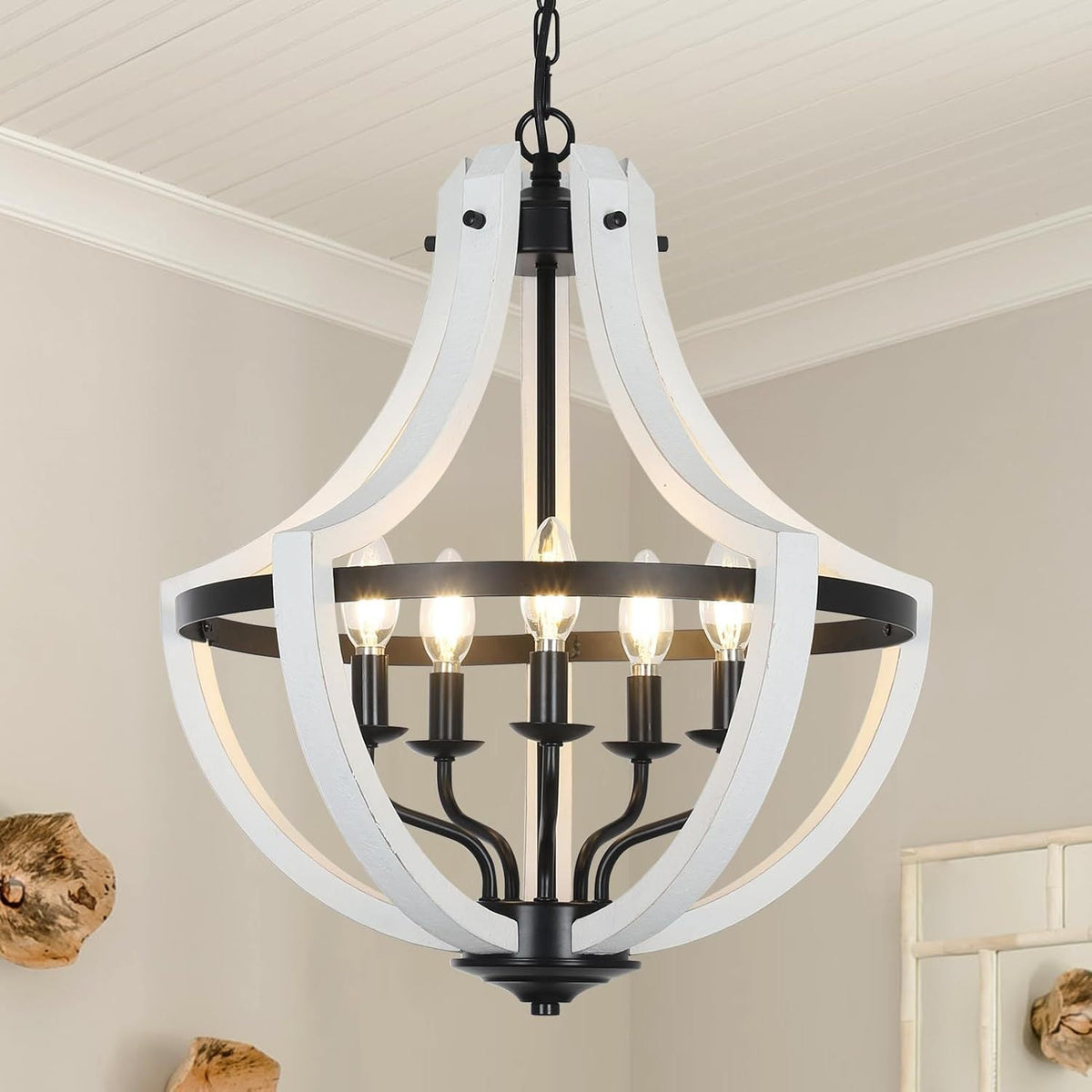 Weathered white wood 5-light farmhouse chandelier with black candle sockets in a dining room