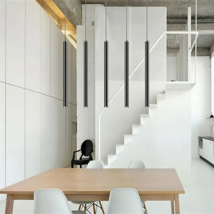 Row of black Ella Nordic long tube LED pendant lights hanging over a modern kitchen island