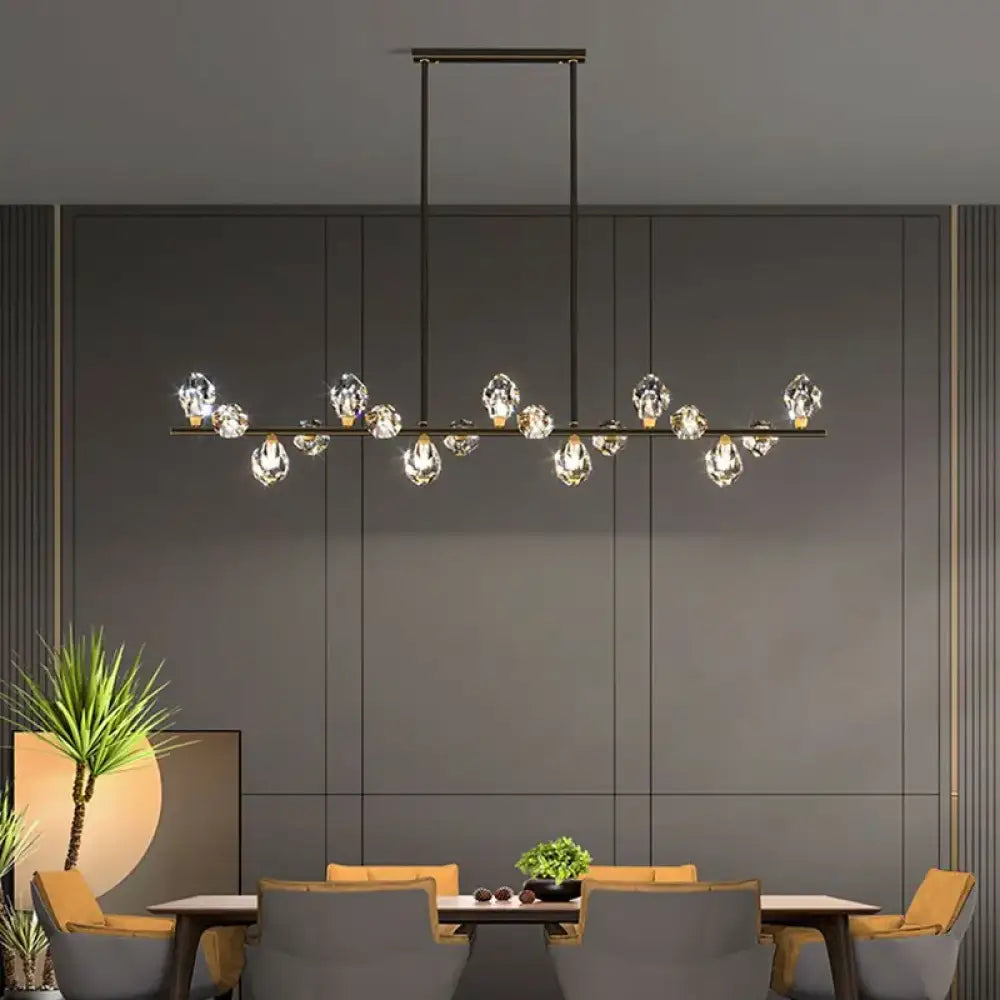Gold crystal chandelier pendant light with multiple sparkling heads above an elegant dining table