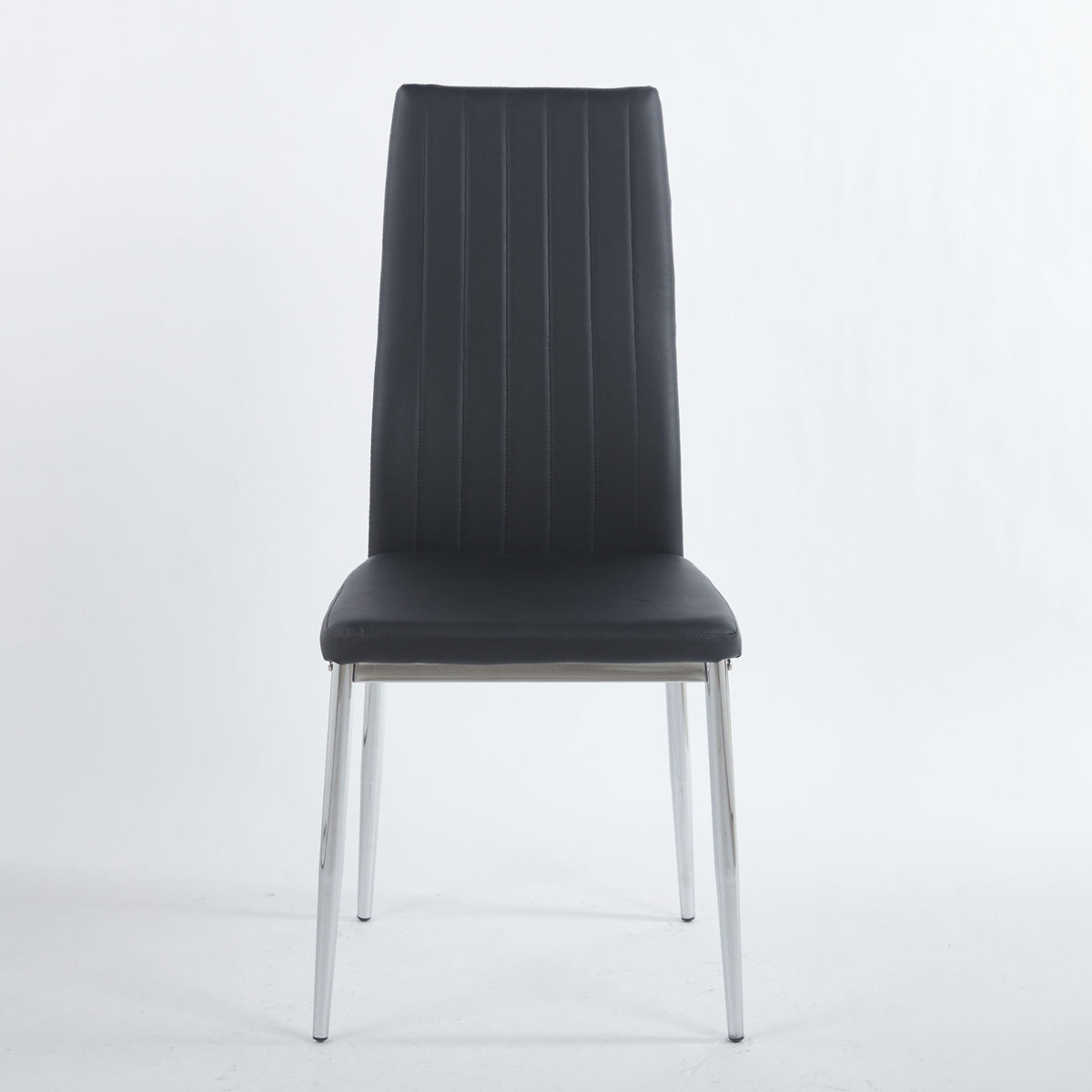 Four minimalist white faux leather dining chairs with metal frames around a modern dining table