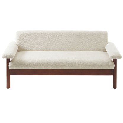 Beige fabric loveseat sofa with armrest pillows in a bright modern living room