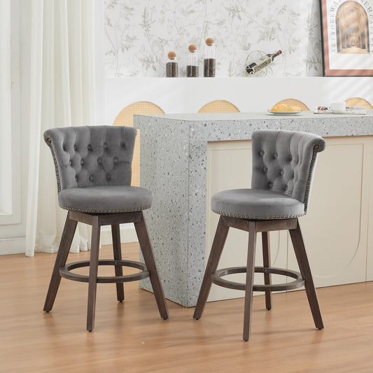 Two gray velvet tufted swivel counter height bar stools at a modern kitchen island