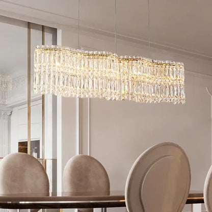 Gold frame flower wave crystal LED chandelier above a dining table