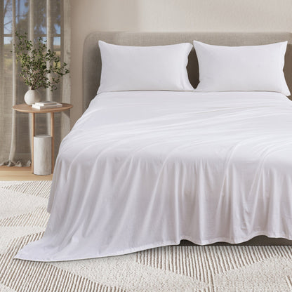 Fog grey bamboo and cotton jersey knit sheet set on a relaxed, inviting bed