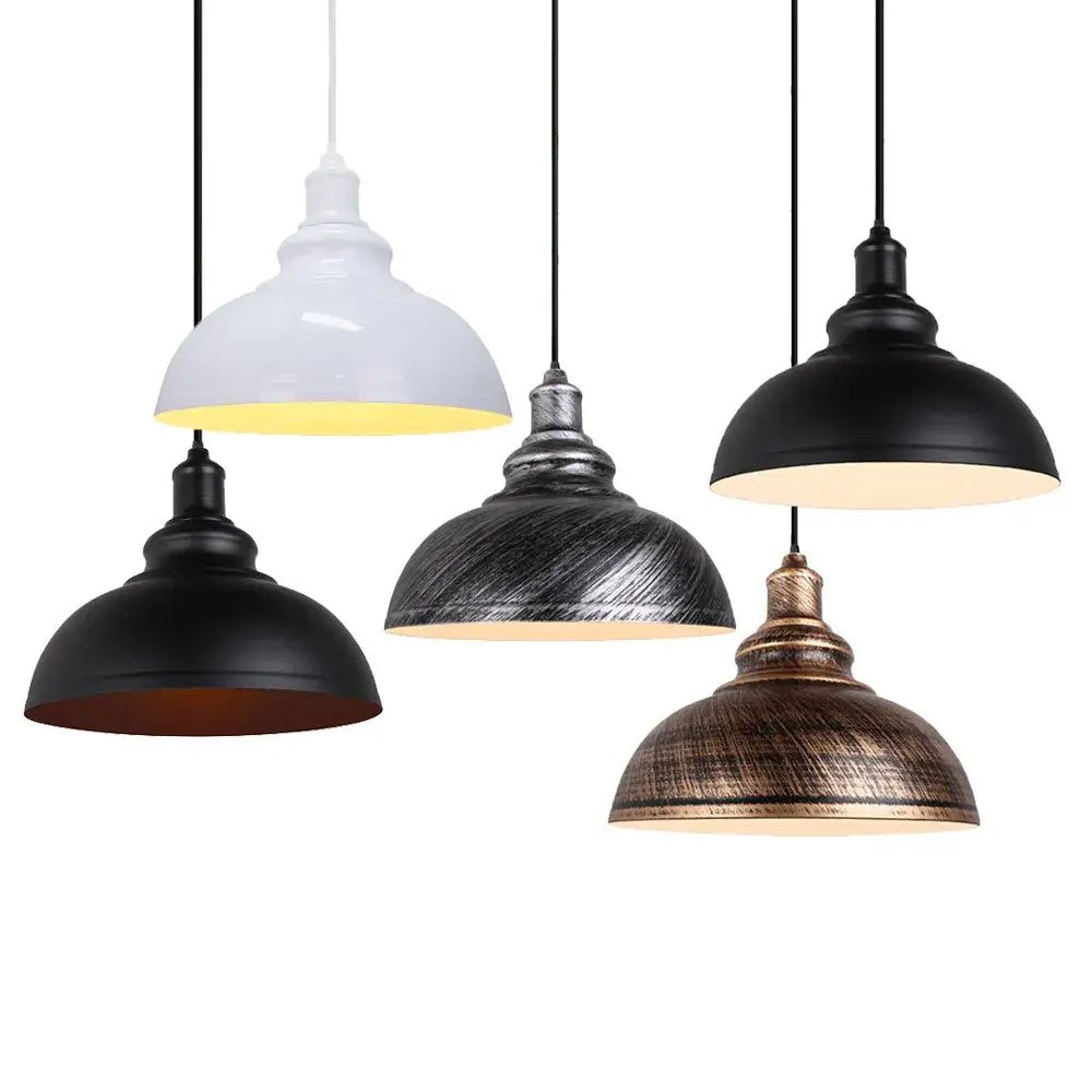 Black retro industrial loft pendant lights hanging in a row over a kitchen island