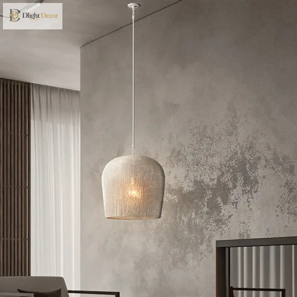 Handmade white rattan Japanese Wabi-Sabi LED pendant light glowing over a wooden dining table