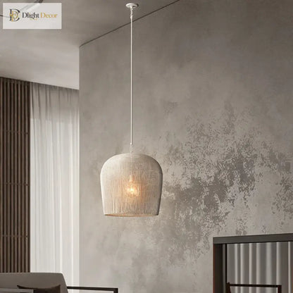 Handmade white rattan Japanese Wabi-Sabi LED pendant light glowing over a wooden dining table