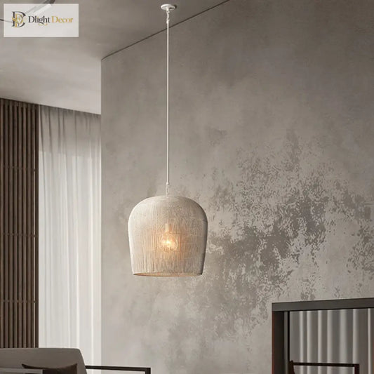 Handmade white rattan Japanese Wabi-Sabi LED pendant light glowing over a wooden dining table