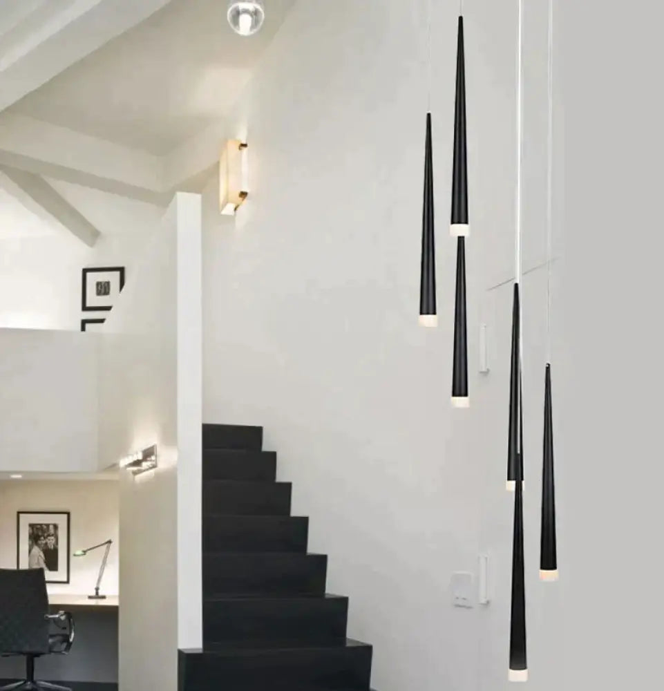 Black Kaia aluminum cone pendant lights in a row above a kitchen island