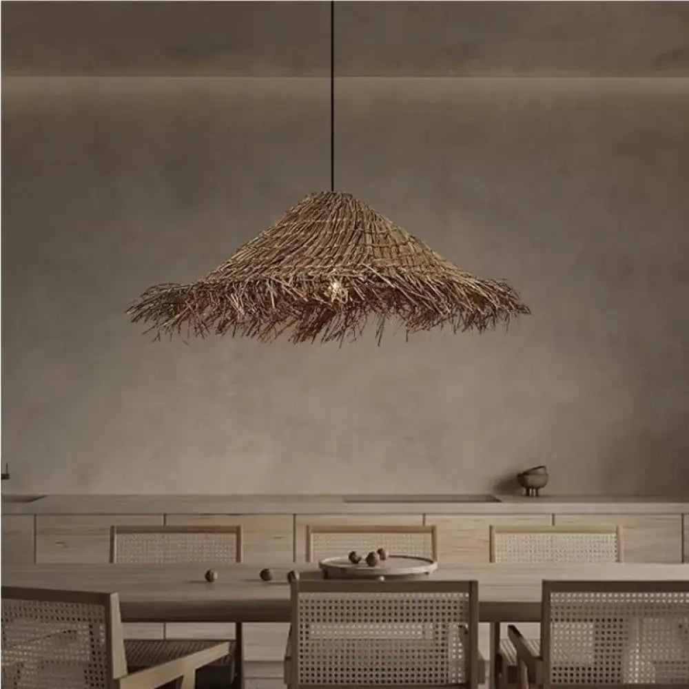 Natural woven Kaia Wabi-Sabi rattan pendant light hanging above a dining table