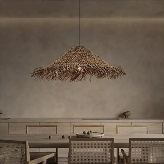 Natural woven Kaia Wabi-Sabi rattan pendant light hanging above a dining table