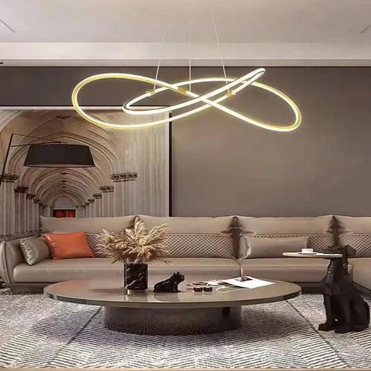 Modern gold dimmable LED pendant light hanging in a bright contemporary living room